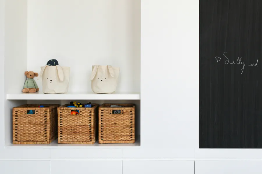 An organized family storage space with labeled baskets