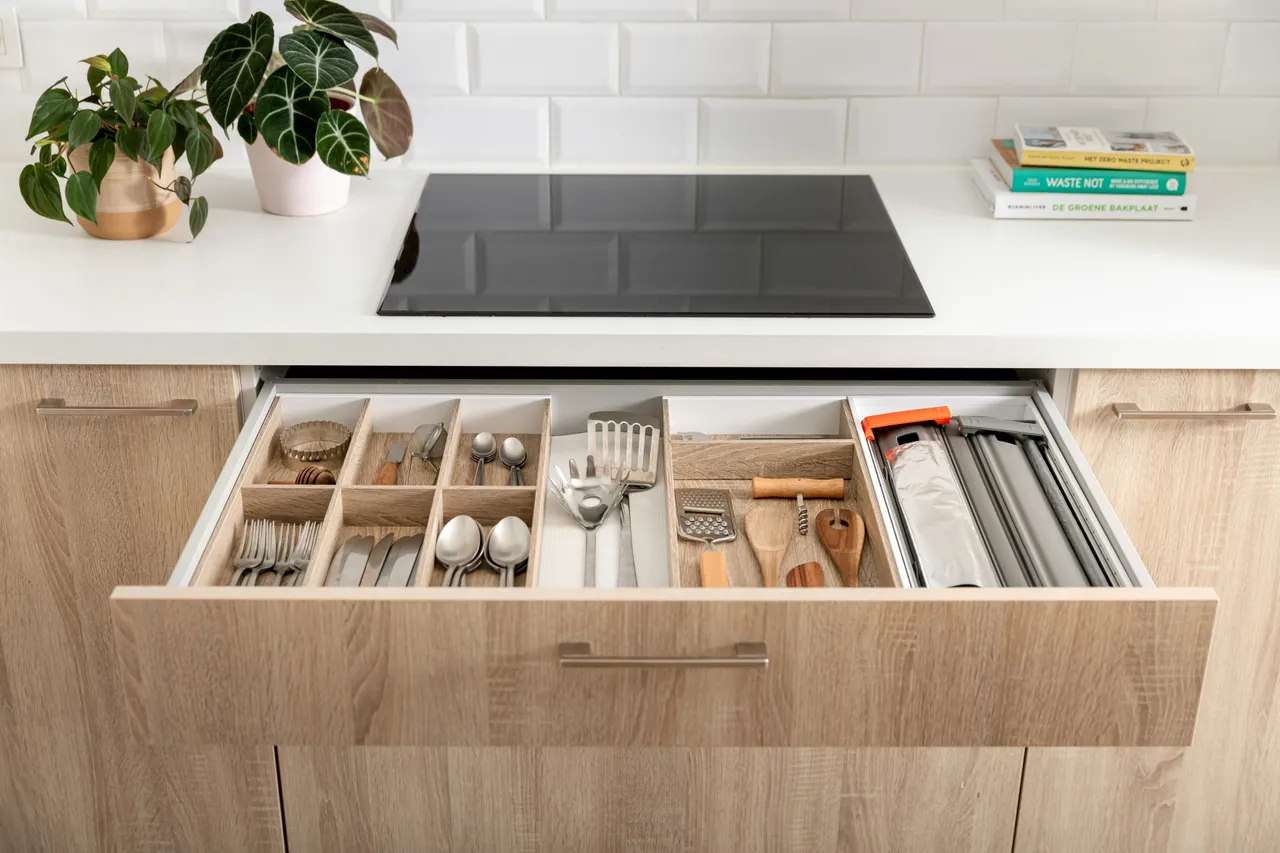 An organized kitchen drawer with neatly arranged utensils